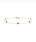 14K yellow gold bezel set garnet station bracelet