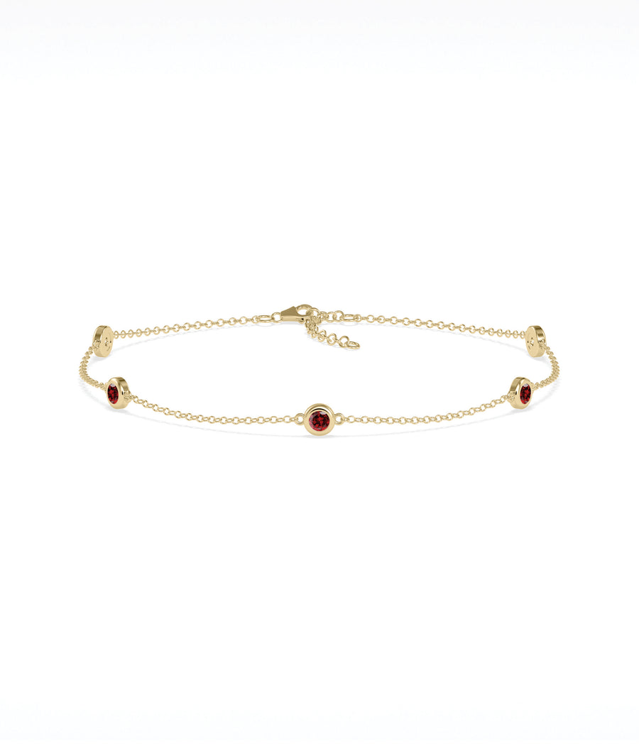 14K yellow gold bezel set garnet station bracelet
