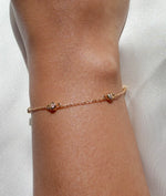 Model wearing yellow gold bezel set diamond station bracelet