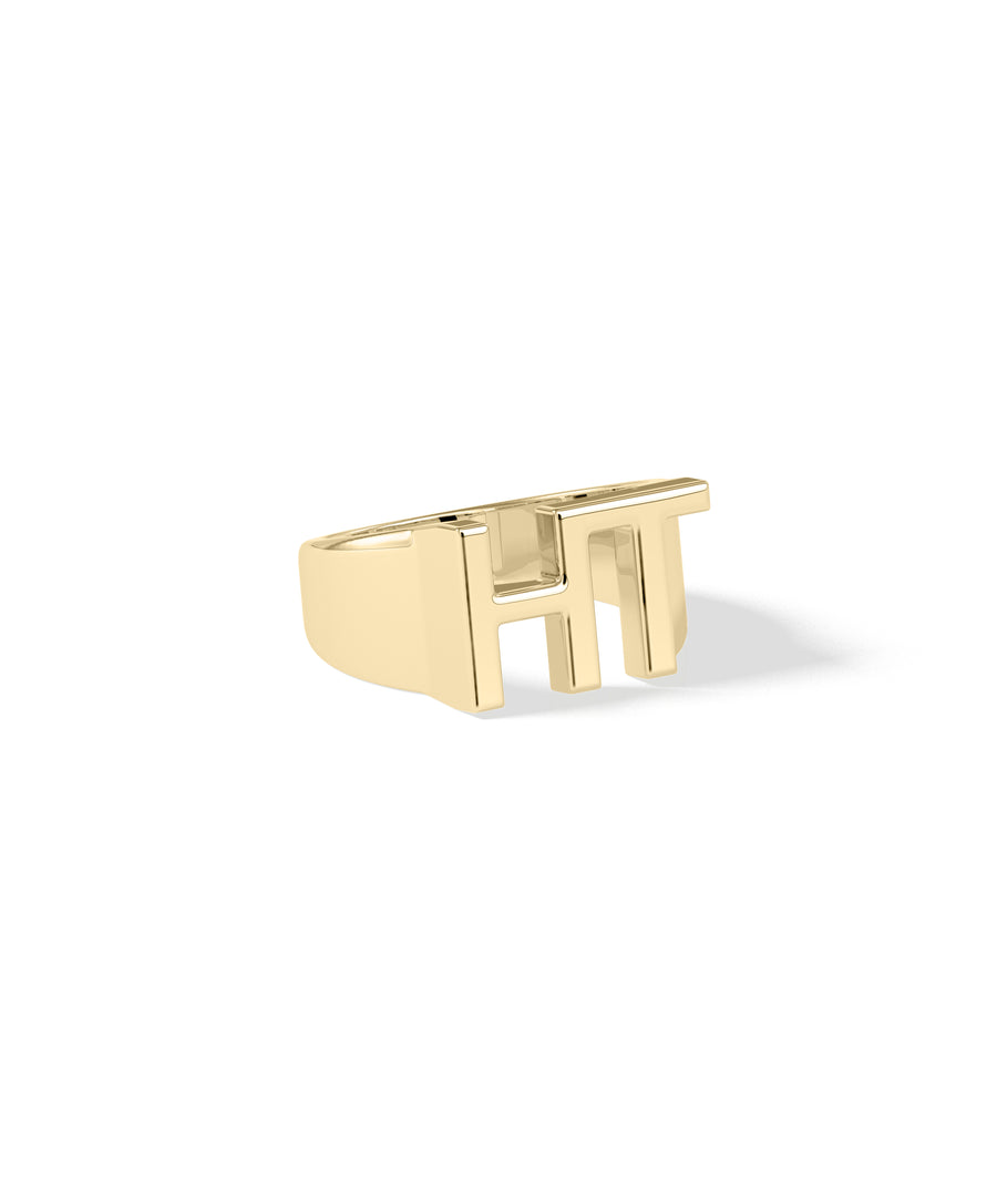 Bold gold initials ring in yellow gold side profile view
