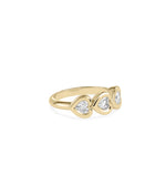 Side profile view of bubble bezel heart diamond band ring in 14K yellow gold