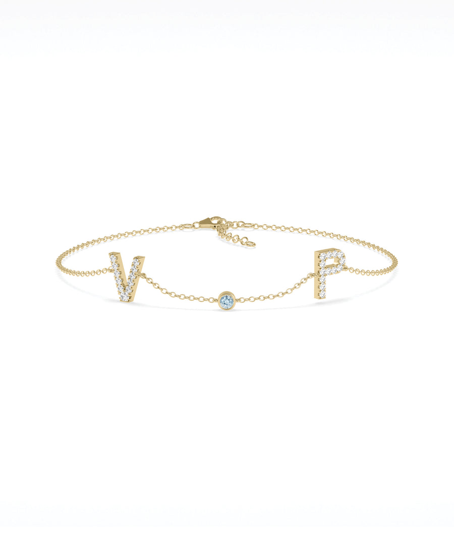 Custom initials solitaire bracelet in 14K yellow gold with aquamarine gemstone