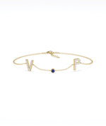 Custom initials solitaire bracelet in 14K yellow gold with blue sapphire