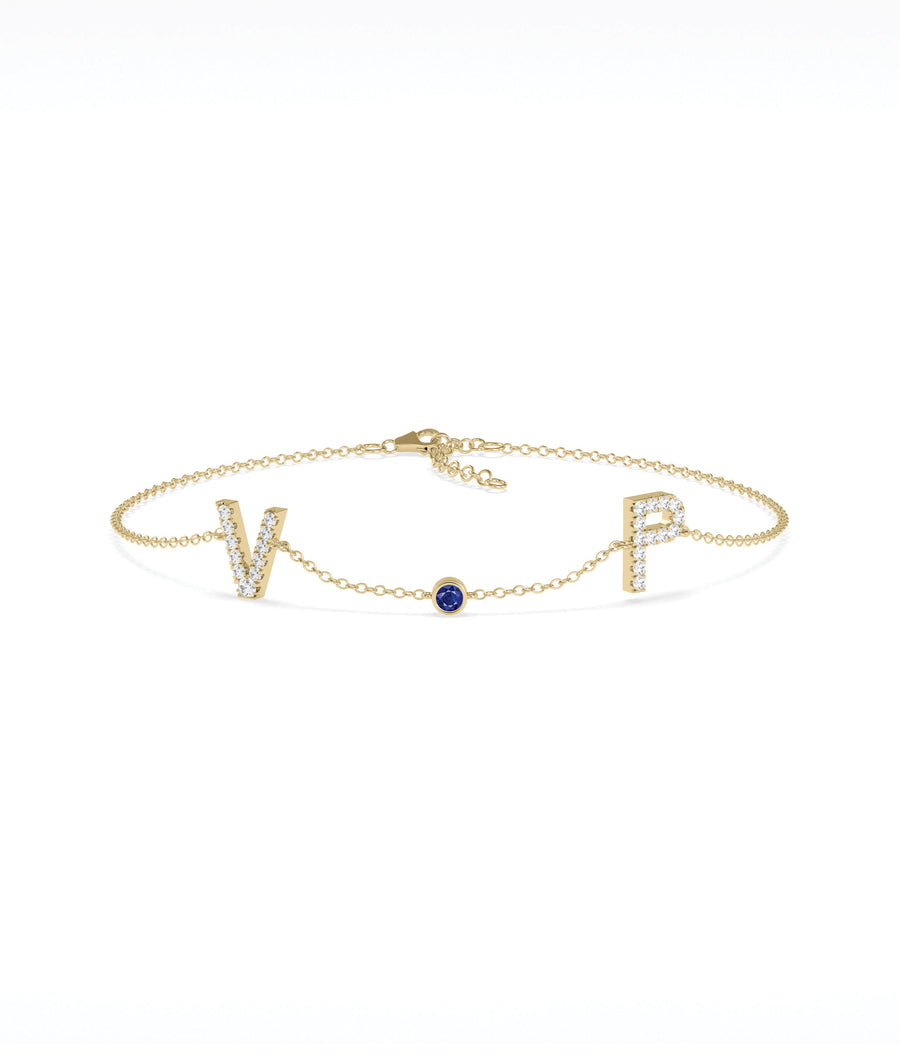 Custom initials solitaire bracelet in 14K yellow gold with blue sapphire