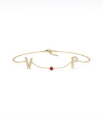 Custom initials solitaire bracelet in 14K yellow gold with ruby gemstone