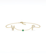 Custom initials solitaire bracelet in 14K yellow gold with emerald gemstone
