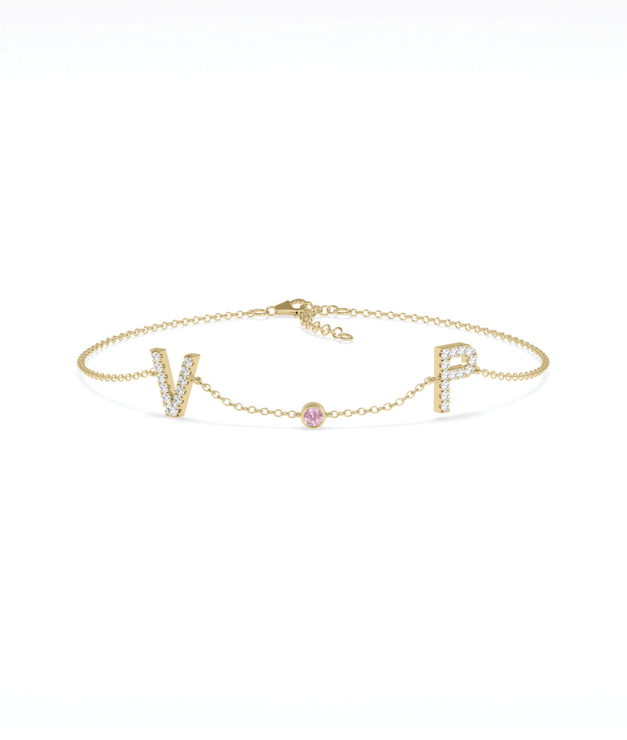 Custom initials solitaire bracelet in yellow gold with pink sapphire gemstone