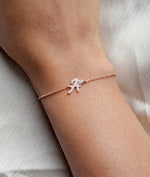 Model wearing diamond graduating bezel bracelet in rose gold