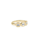 Emerald cut bezel diamond band ring in 14K yellow gold side view