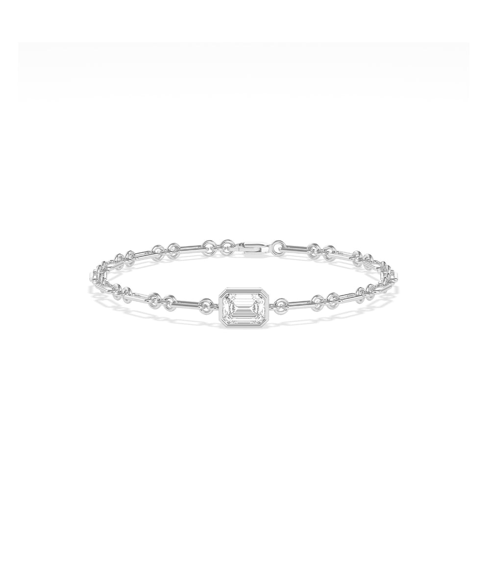 White gold chain bracelet featuring a bezel-set emerald-cut diamond centerpiece with bar and circle links
