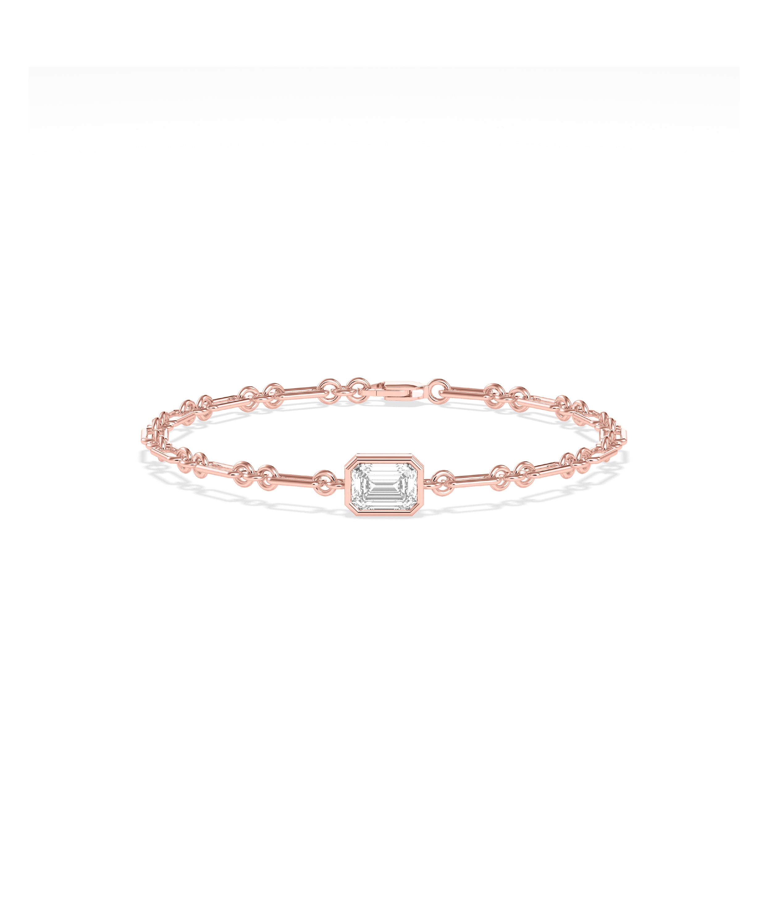 Rose gold chain bracelet featuring a bezel-set emerald-cut diamond solitaire centerpiece
