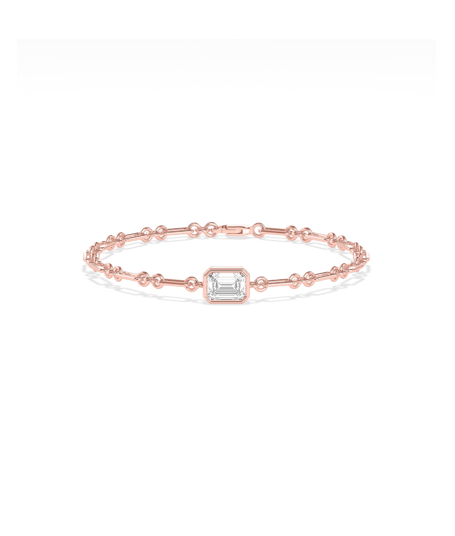 Rose gold chain bracelet featuring a bezel-set emerald-cut diamond solitaire centerpiece