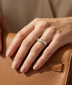 Model wearing emerald cut wave band ring in 14K yellow gold