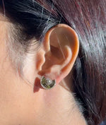 Model wearing yellow gold fan stud earrings in 14K solid gold