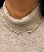 Model wearing flexible diamond choker necklace in yellow gold