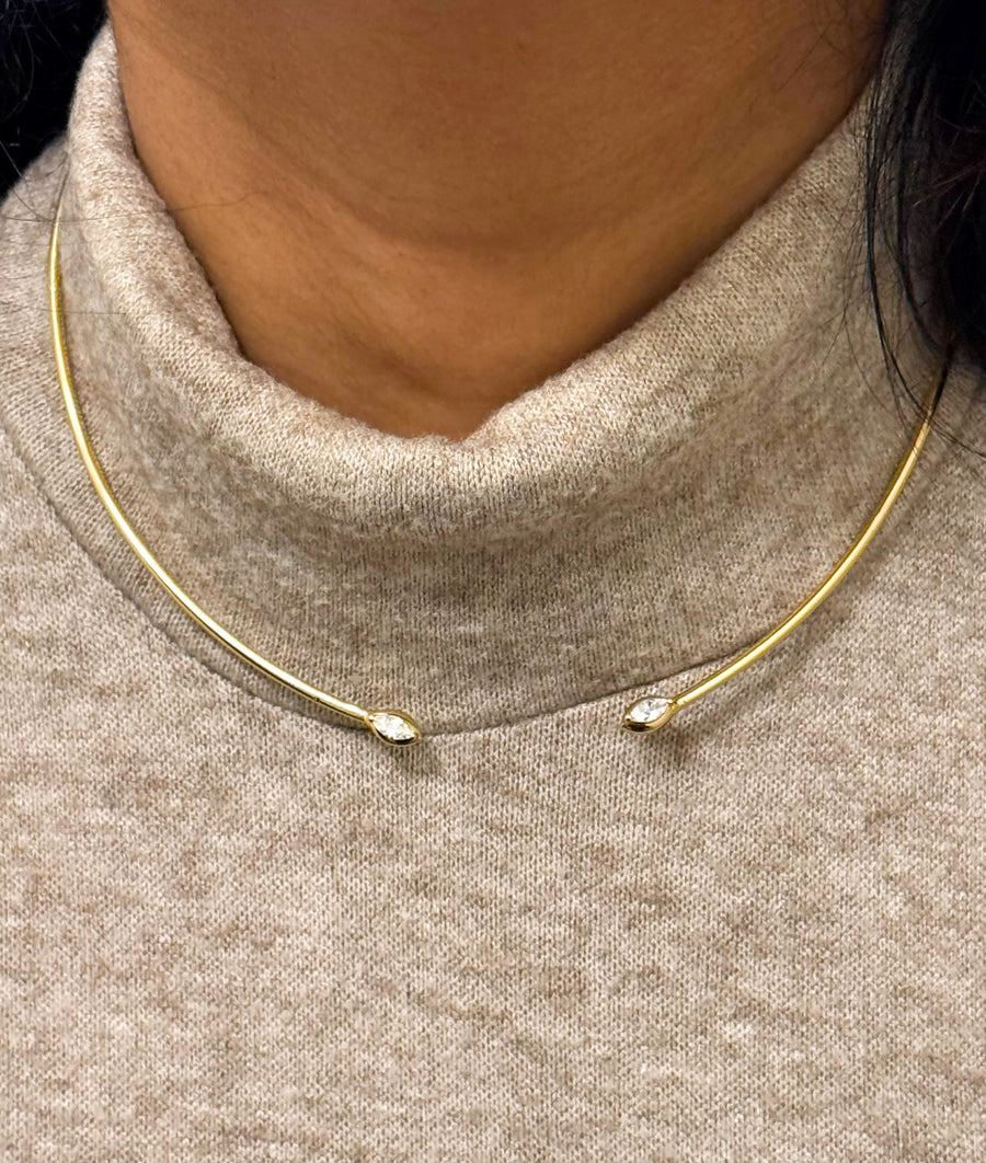 Model wearing flexible diamond choker necklace in yellow gold