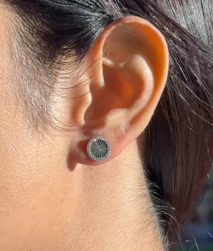 Model wearing fluted diamond round stud earrings in yellow gold