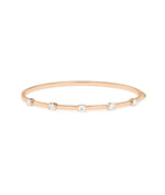 Half bezel round lab diamond bangle in 14K rose gold