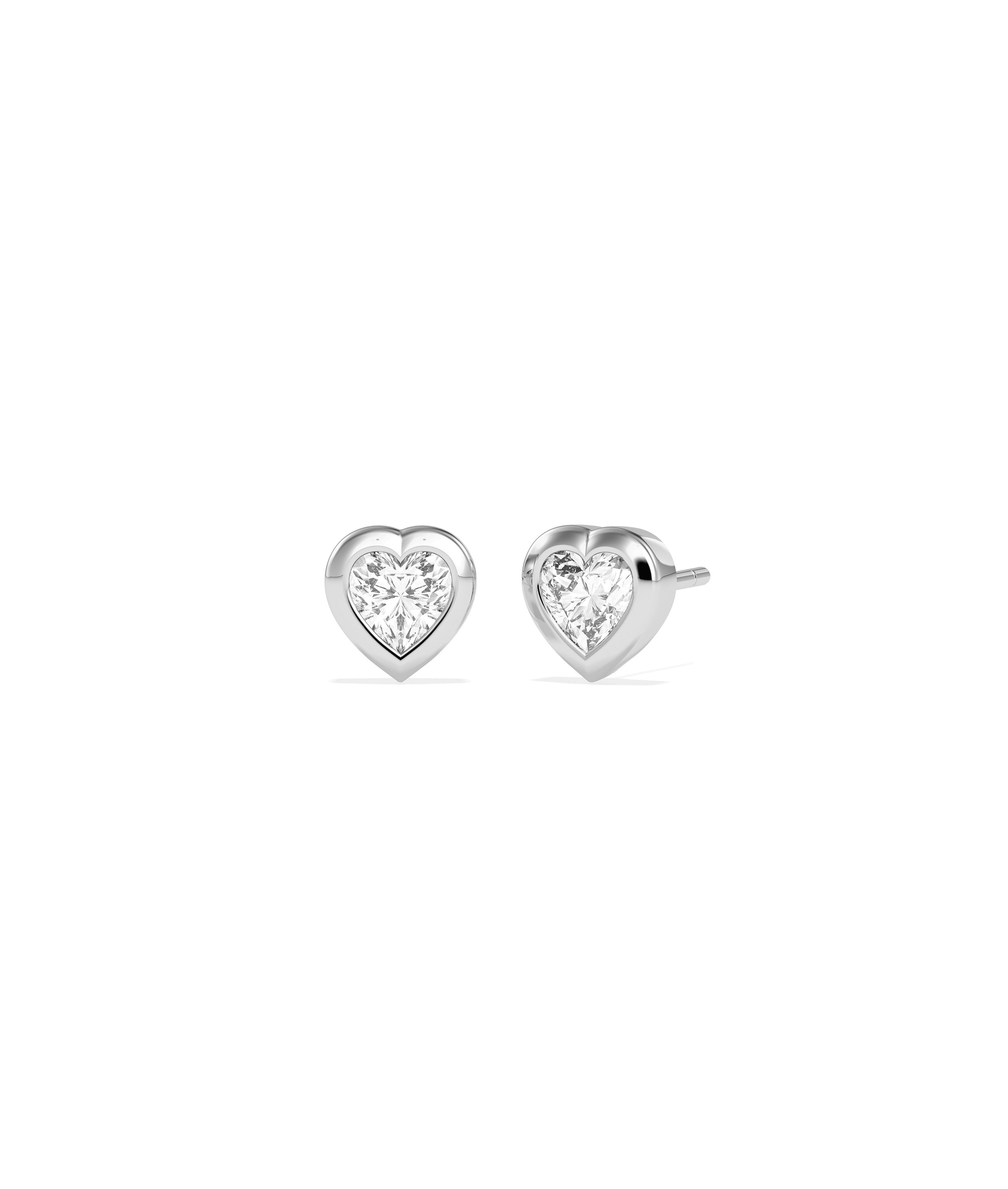 Heart-shaped diamond bezel set stud earrings in white gold, shown as a pair front and side view