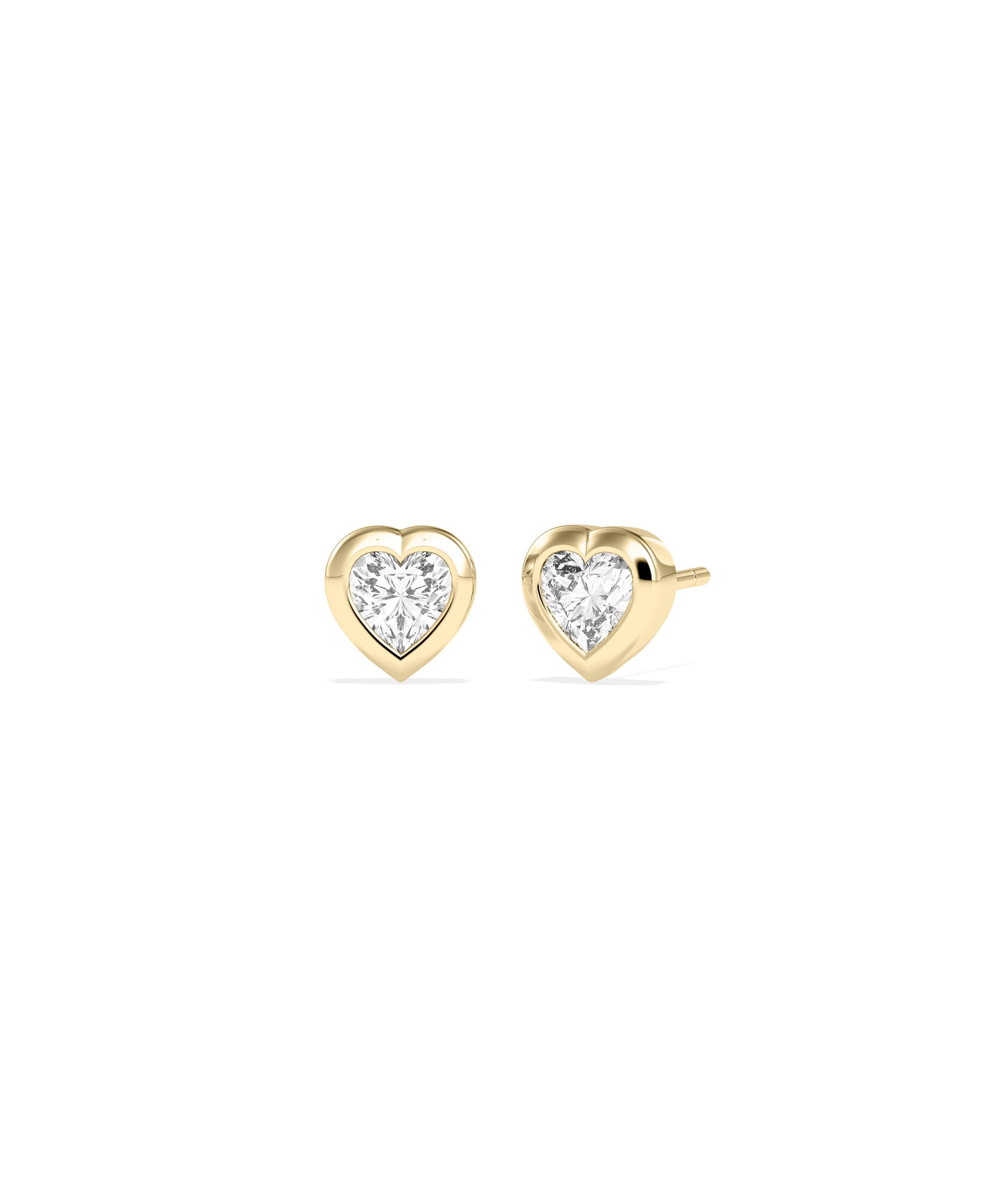 Heart-shaped diamond bezel set stud earrings in yellow gold, shown as a pair with push-back closures.