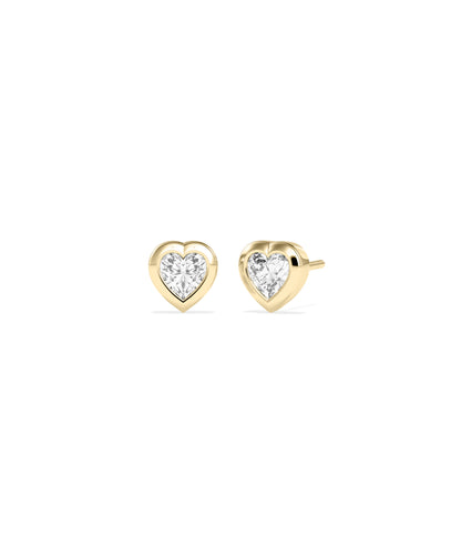 Heart-shaped diamond bezel set stud earrings in yellow gold, shown as a pair with push-back closures.