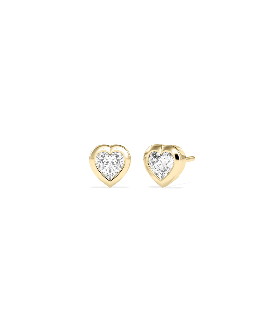 Heart-shaped diamond bezel set stud earrings in yellow gold, shown as a pair with push-back closures.