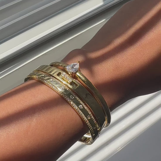 Solitaire Cuff Bangle on display showcasing solid 14K gold construction