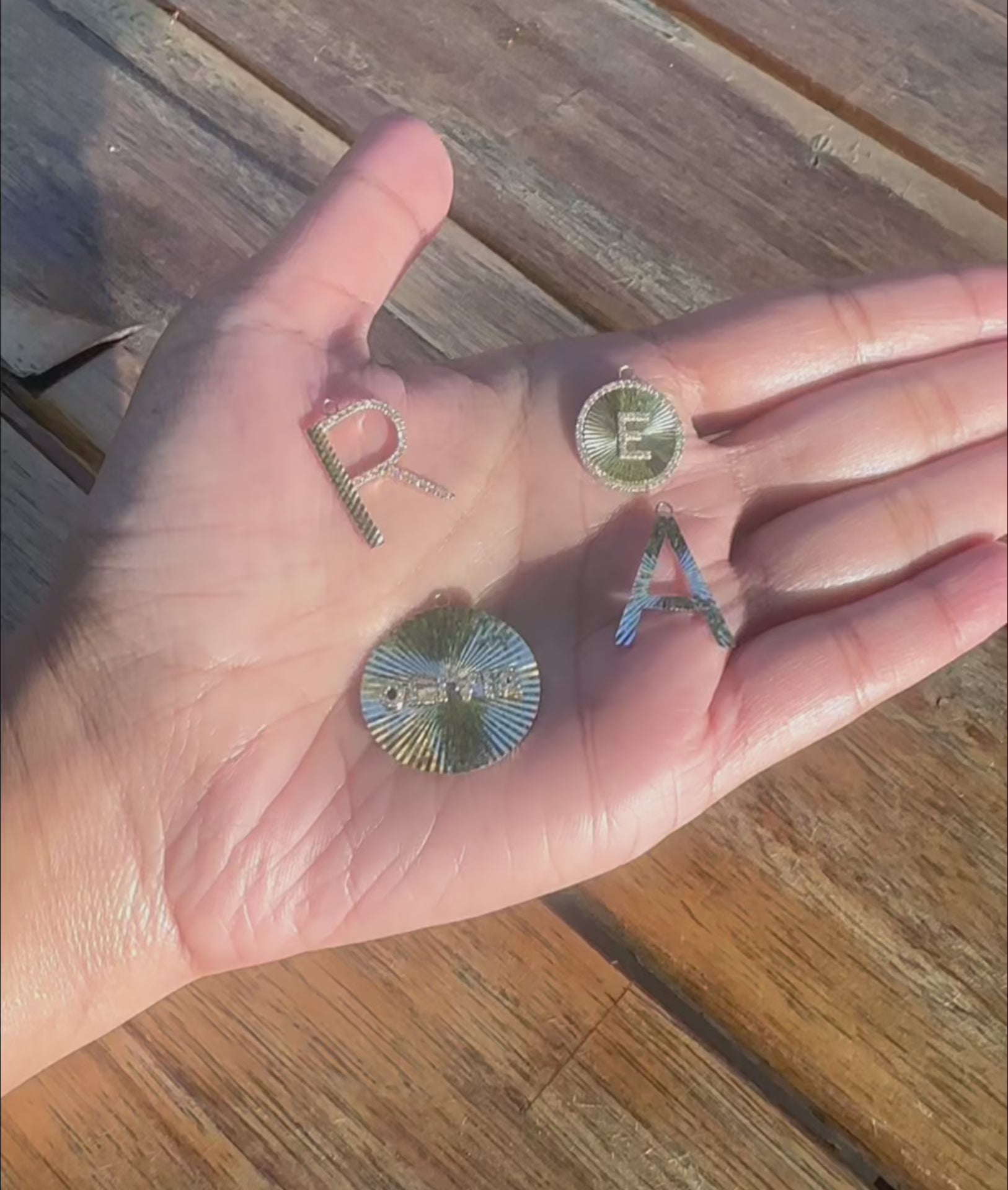 Fluted diamond initial charm styled as pendant showing statement-making size