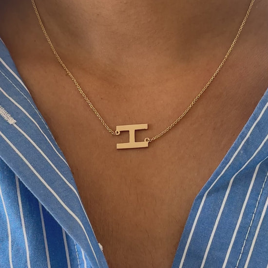 Gold Horizontal Initial Necklace worn on neckline displaying minimalist bar styling
