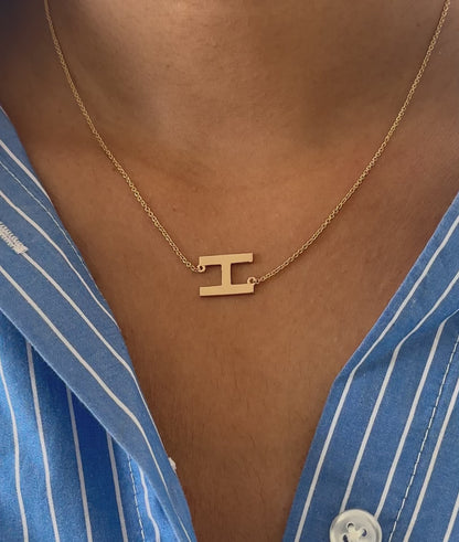 Gold Horizontal Initial Necklace worn on neckline displaying minimalist bar styling