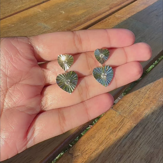 Fluted heart texture detail diamond solitaire earring close-up