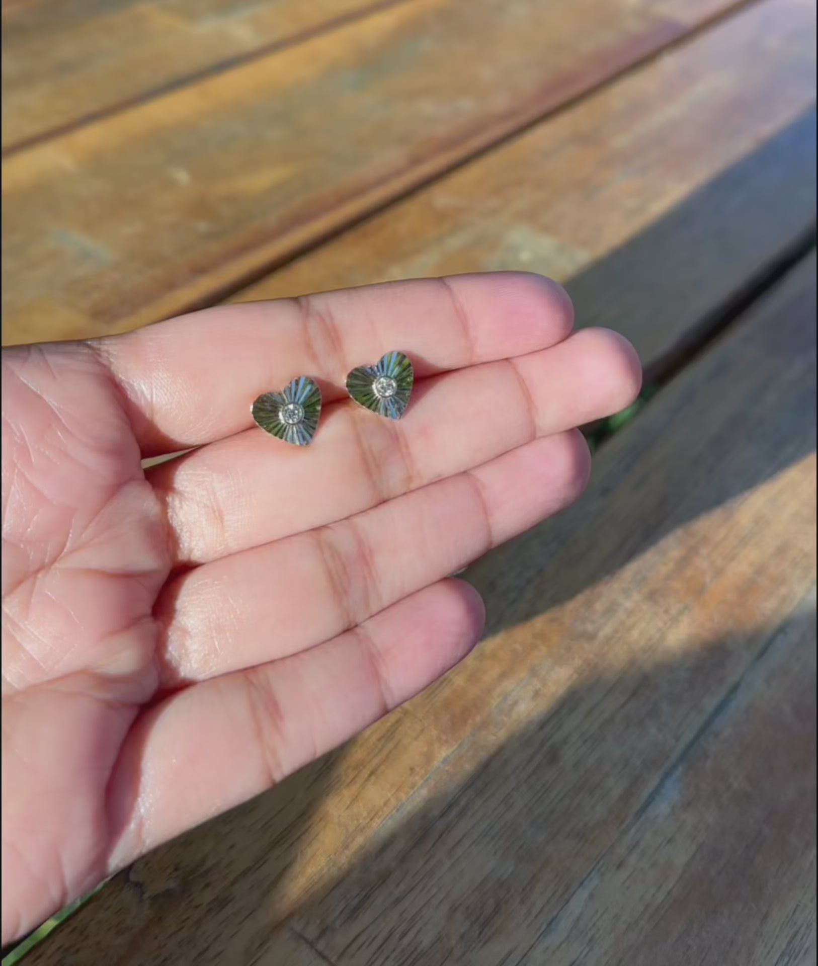 Fluted heart stud earrings lifestyle photo displaying versatile love symbol styling