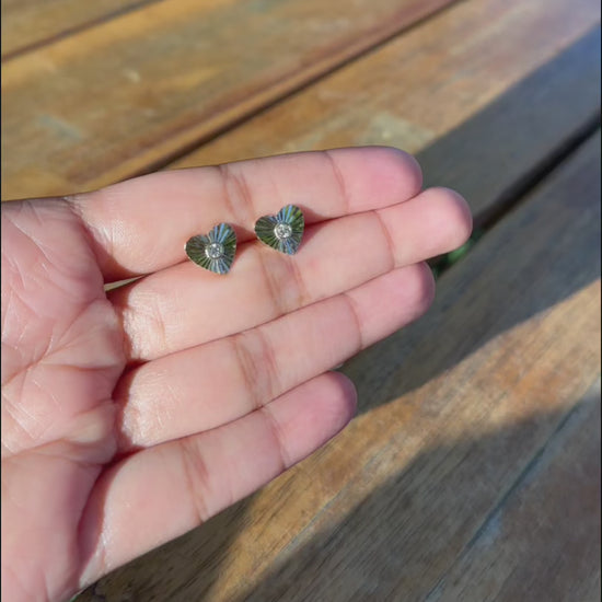 Fluted heart stud earrings lifestyle photo displaying versatile love symbol styling