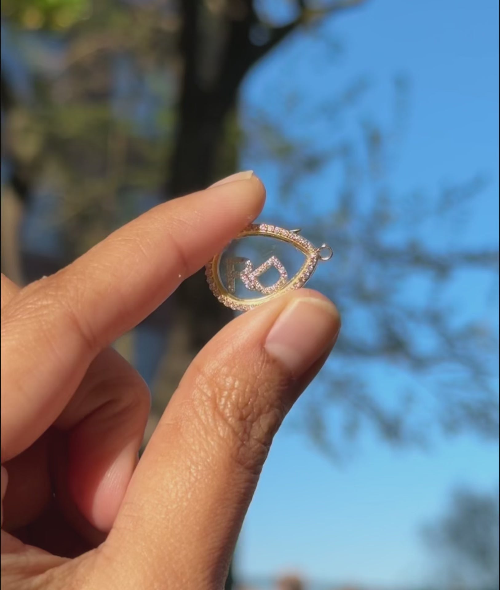 Diamond pear shape glass locket charm beautifully displayed on upscale jewelry presentation