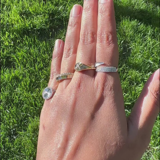 Fluted diamond band ring styled in stacked ring arrangement with other bands