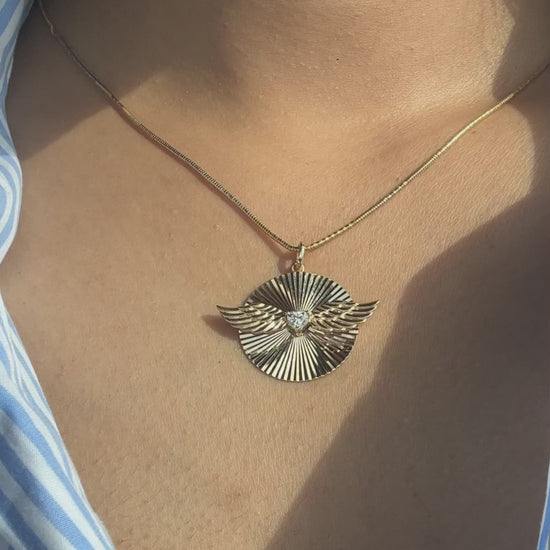 Fluted solitaire wings charm styled as pendant showing impressive wingspan