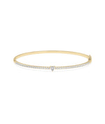 Straight line diamond bangle with solitaire in 14K yellow gold