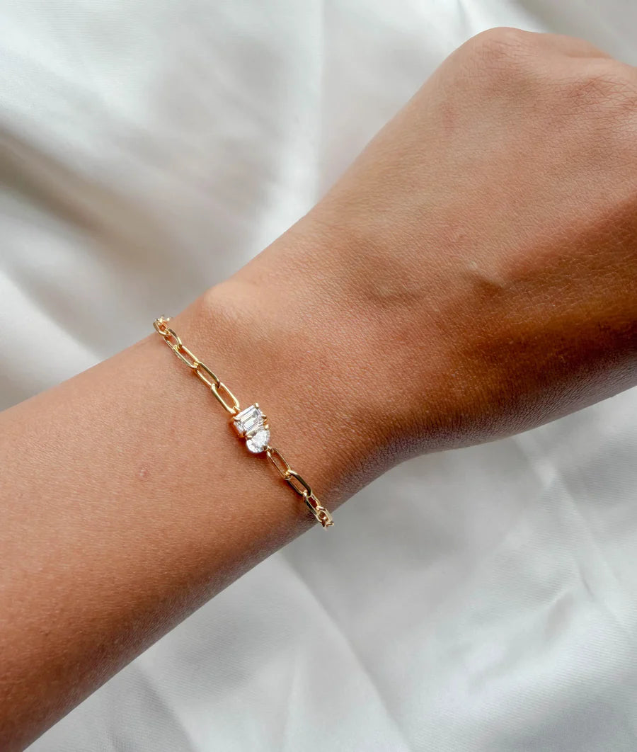 Model wearing Toi Et Moi solitaire paper clip bracelet in yellow gold