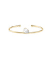 Yellow gold open cuff bracelet featuring a pear-shaped diamond solitaire in a prong setting