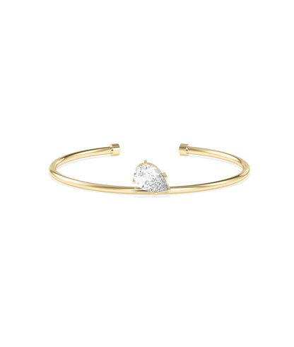 Yellow gold open cuff bracelet featuring a pear-shaped diamond solitaire in a prong setting